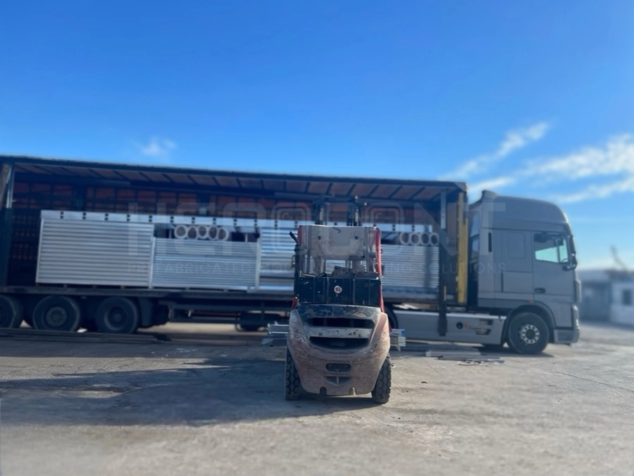 Loading modular containers onto trucks for shipment